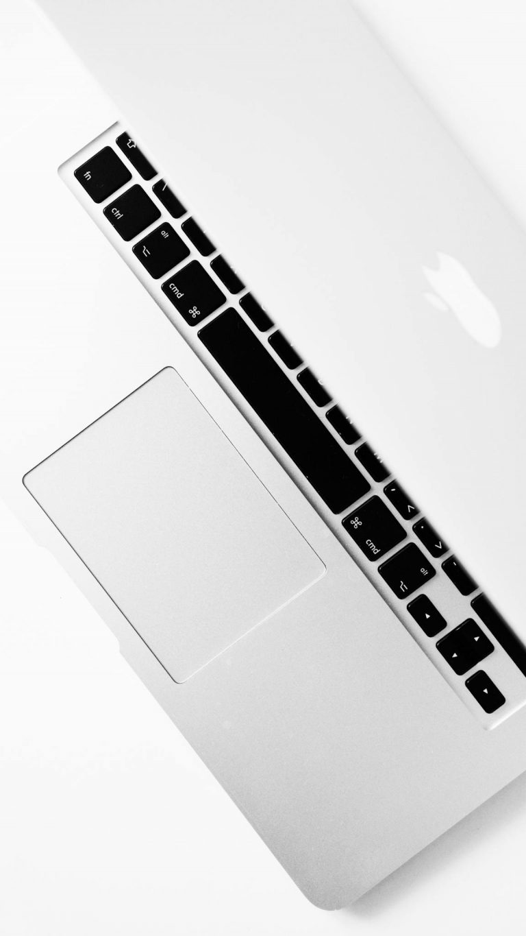 Aerial shot of a sleek silver laptop keyboard with open screen, ideal for tech themes.